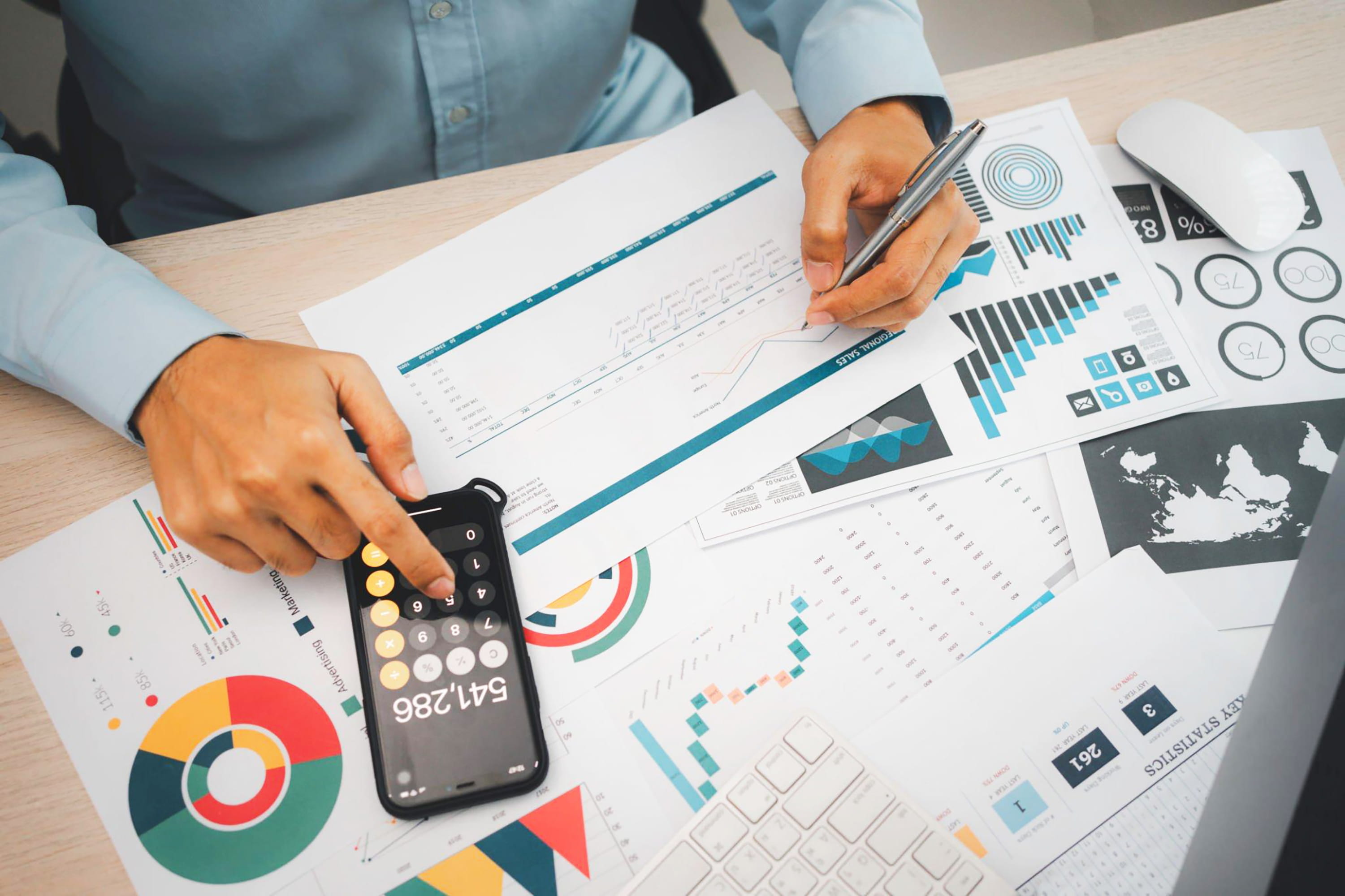 person-is-sitting-desk-with-calculator-paper-with-graph